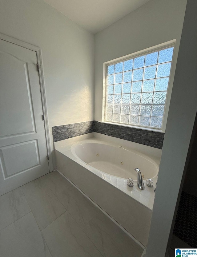 full bathroom featuring a jetted tub