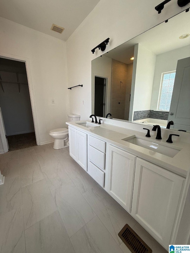 full bathroom featuring marble finish floor, a sink, and visible vents