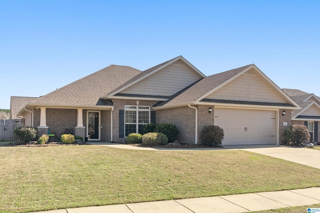 craftsman house featuring a garage and a front lawn