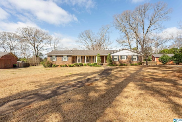 ranch-style home featuring a front yard