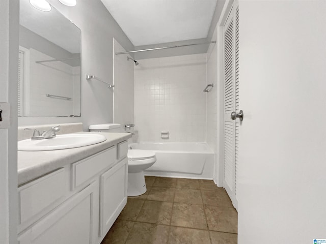 full bathroom featuring tiled shower / bath combo, tile patterned floors, vanity, and toilet