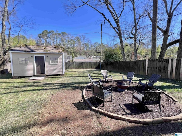 view of yard featuring an outdoor fire pit and a storage shed