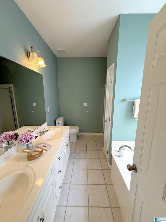 full bathroom with tile patterned flooring, double vanity, a sink, and a bath