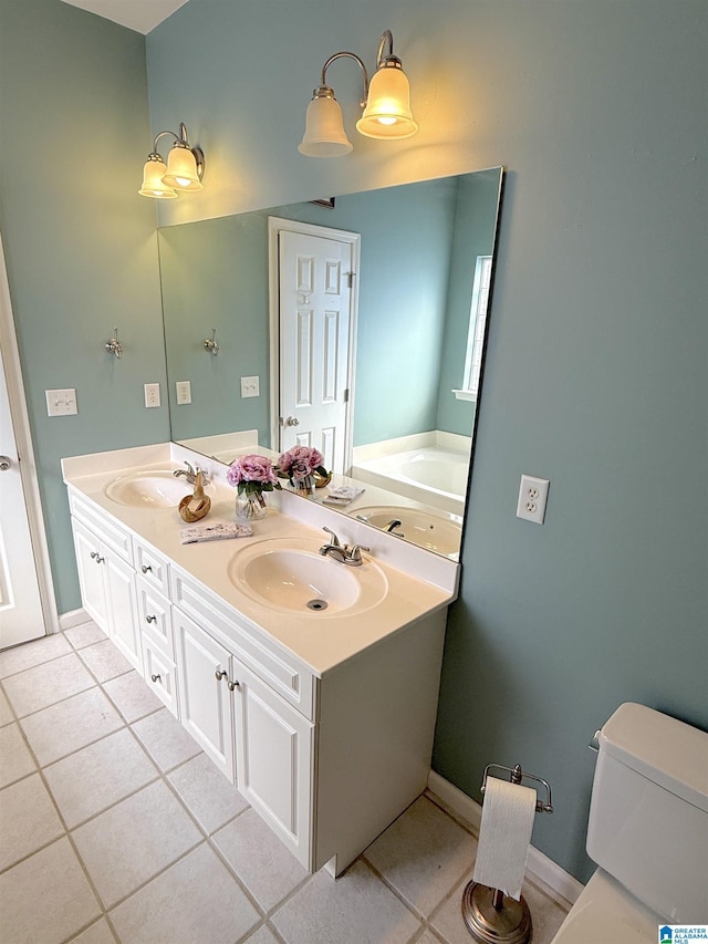 bathroom featuring tile patterned flooring, a sink, toilet, and double vanity