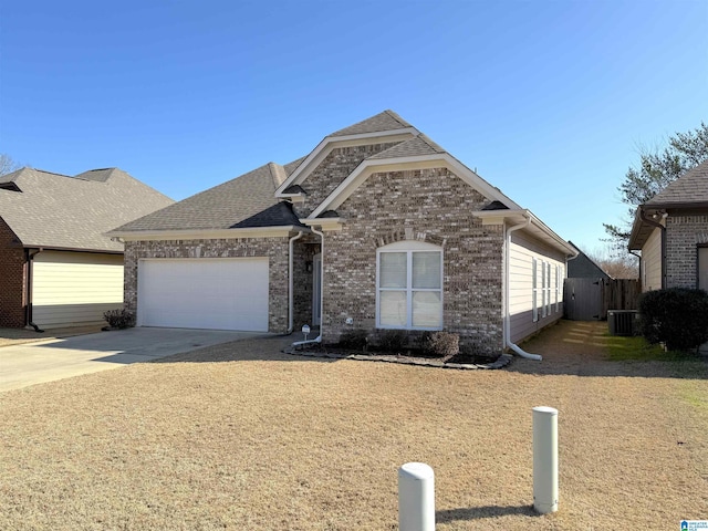 view of front facade featuring a garage, driveway, central AC unit, roof with shingles, and brick siding