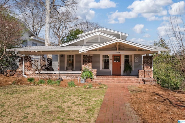 view of front of home featuring covered porch and a front yard