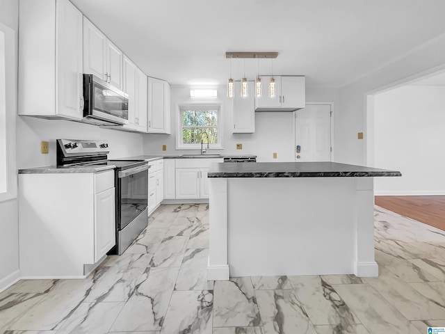 kitchen with marble finish floor, hanging light fixtures, appliances with stainless steel finishes, white cabinetry, and a sink