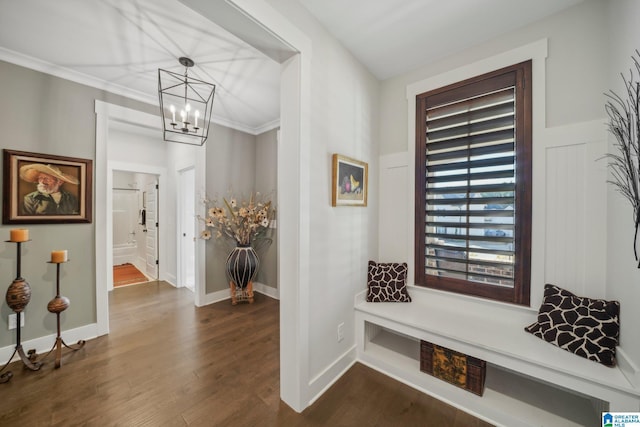 interior space with an inviting chandelier, dark hardwood / wood-style flooring, and ornamental molding