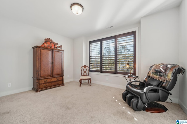 sitting room featuring light colored carpet