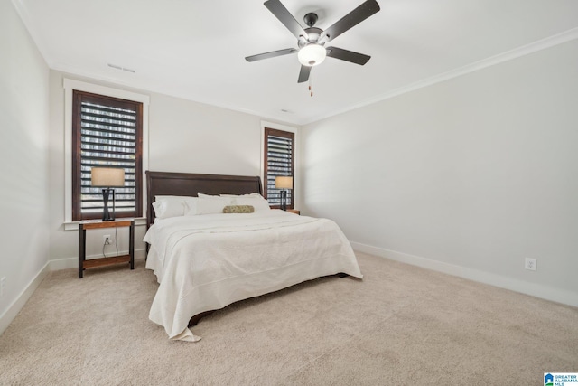 carpeted bedroom featuring ceiling fan and crown molding