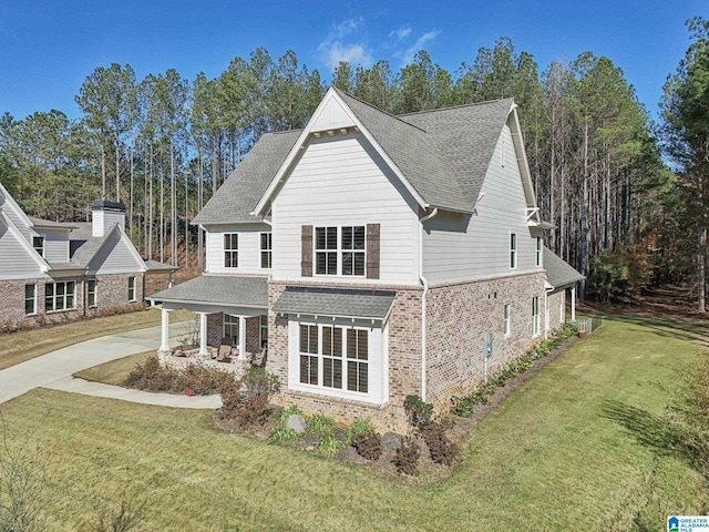 view of front of property with covered porch and a front lawn