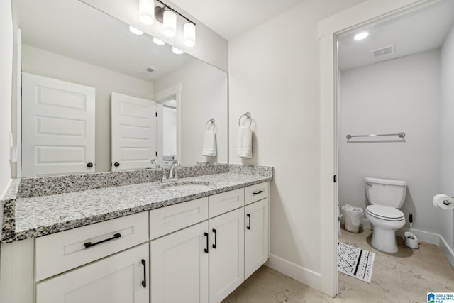 bathroom with toilet and vanity