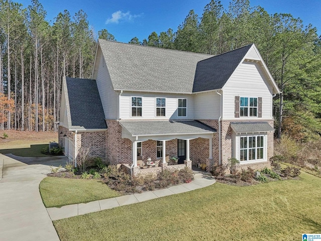 front of property with a front yard, a garage, and a porch