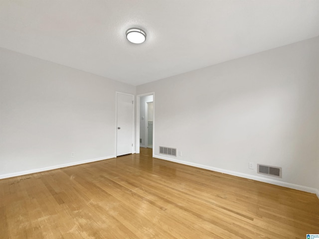 unfurnished room with light wood-type flooring