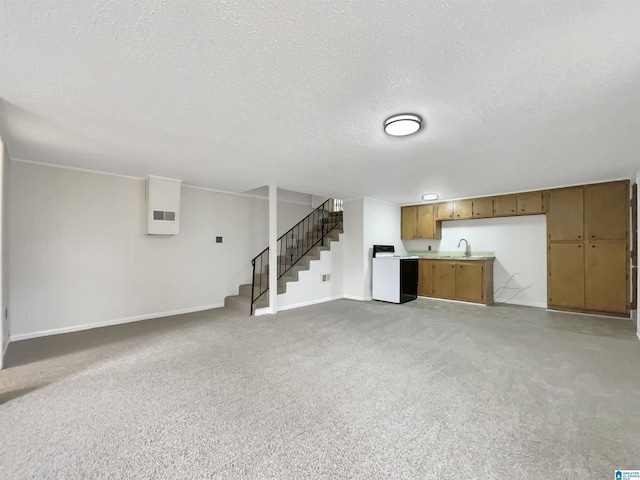 unfurnished living room with light carpet, sink, and a textured ceiling