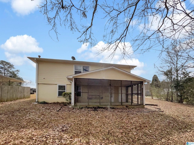 back of property with a sunroom