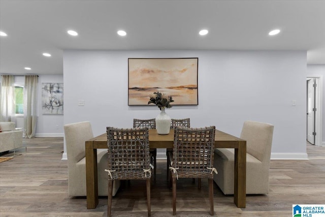 dining space with hardwood / wood-style floors