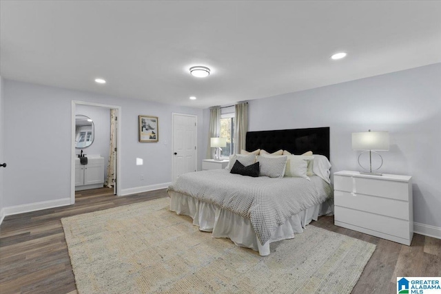 bedroom featuring ensuite bath and wood-type flooring