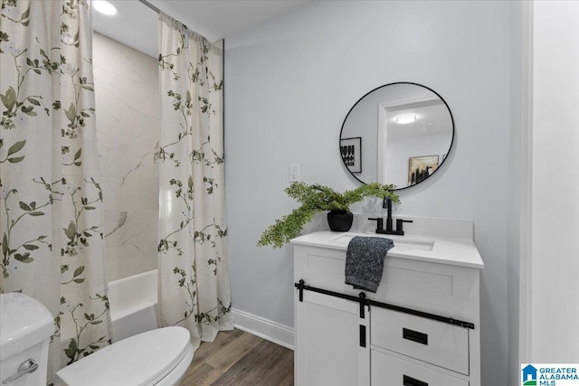 full bathroom featuring hardwood / wood-style flooring, vanity, toilet, and shower / bath combo with shower curtain