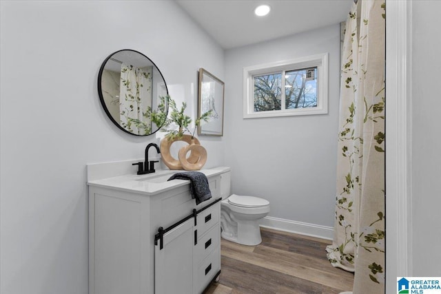 bathroom featuring hardwood / wood-style flooring, vanity, and toilet