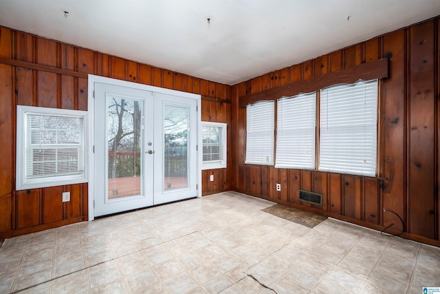 interior space featuring french doors and wood walls