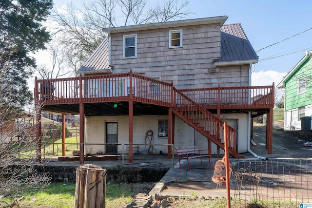 back of house featuring a patio area and a wooden deck