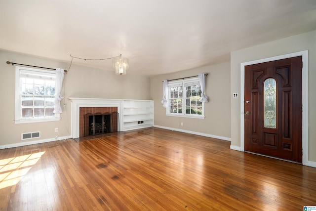 unfurnished living room featuring a fireplace and hardwood / wood-style floors