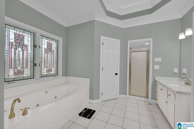 bathroom with a whirlpool tub, tile patterned flooring, ornamental molding, and vanity