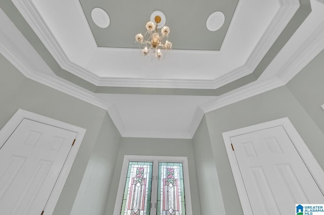 room details featuring french doors, crown molding, and an inviting chandelier