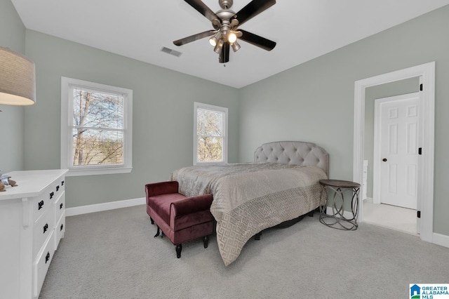 bedroom featuring light colored carpet, visible vents, ceiling fan, and baseboards