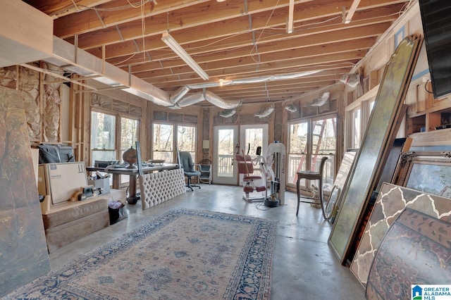 miscellaneous room with concrete flooring and french doors