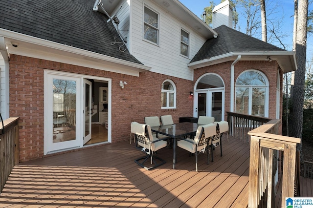 wooden deck featuring french doors and outdoor dining area