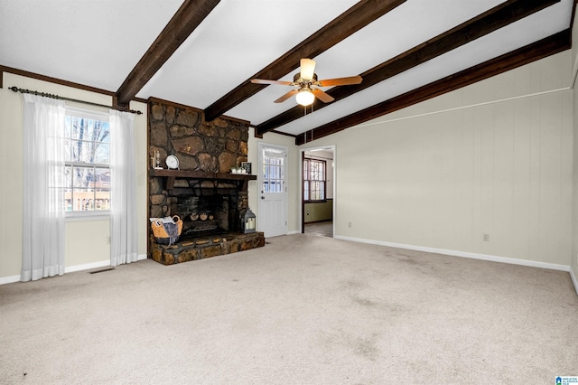 unfurnished living room featuring carpet floors, ceiling fan, lofted ceiling with beams, and a fireplace