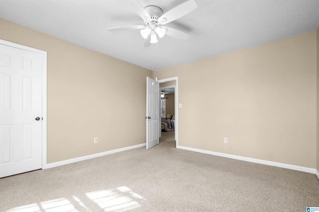 unfurnished bedroom with light carpet and ceiling fan