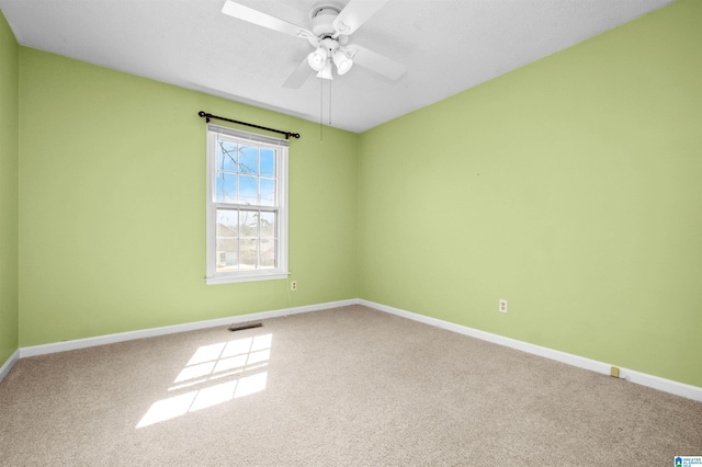 carpeted empty room featuring ceiling fan