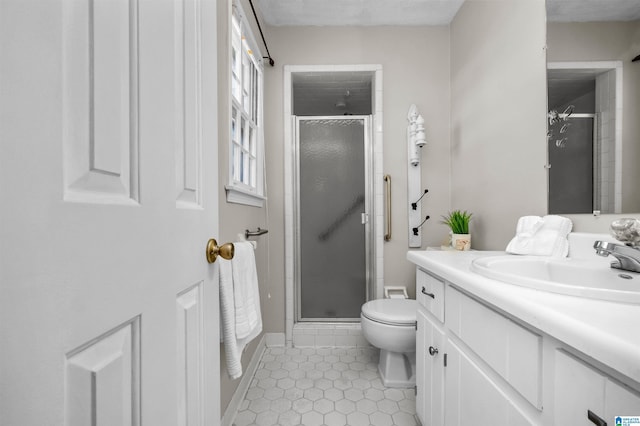 bathroom with tile patterned floors, vanity, toilet, and a shower with door