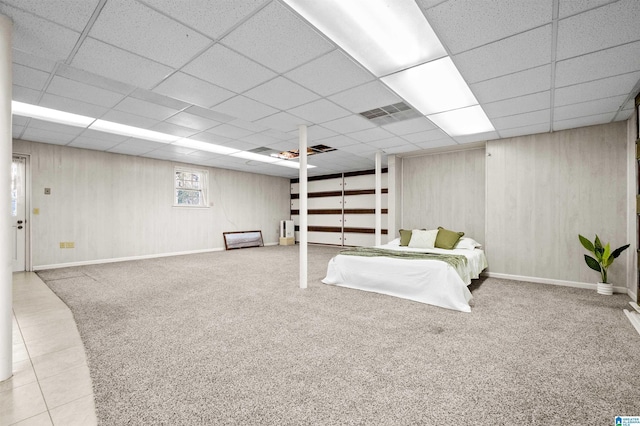 bedroom featuring a drop ceiling and light tile patterned flooring