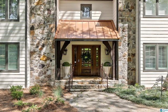 890 River Oaks Dr, Cropwell, AL 35054 - view of exterior entry with stone siding, metal roof, and a standing seam roof