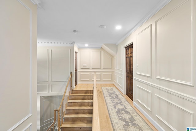 890 River Oaks Dr, Cropwell, AL 35054 - hallway with light wood finished floors, crown molding, stairway, a decorative wall, and recessed lighting
