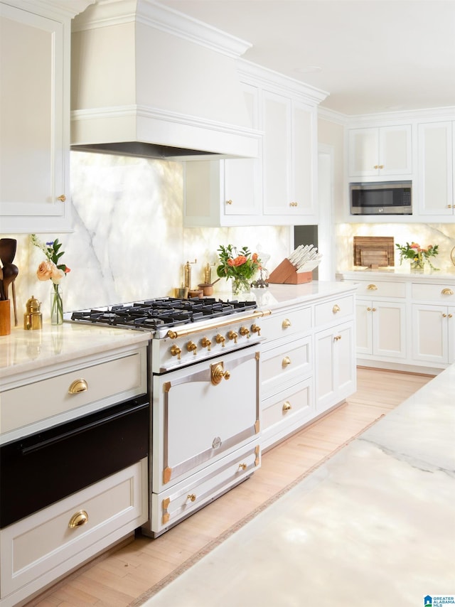 890 River Oaks Dr, Cropwell, AL 35054 - kitchen with tasteful backsplash, stainless steel microwave, custom range hood, high end white range oven, and white cabinets