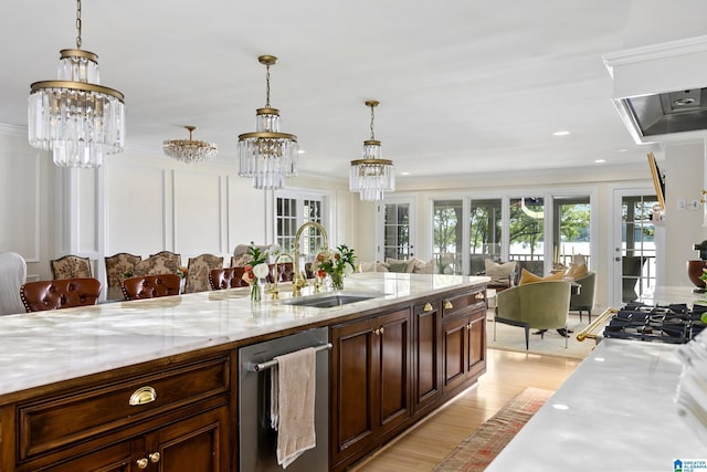 890 River Oaks Dr, Cropwell, AL 35054 - kitchen with dishwasher, a sink, open floor plan, a chandelier, and light wood-style floors