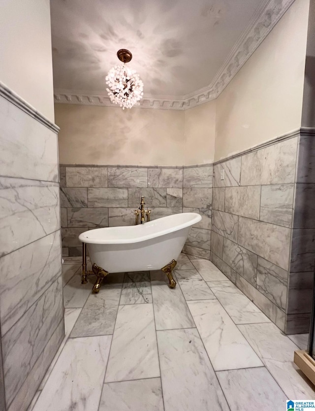 890 River Oaks Dr, Cropwell, AL 35054 - full bathroom featuring a notable chandelier, a soaking tub, tile walls, wainscoting, and marble finish floor