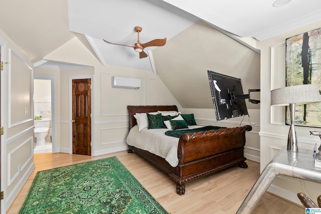 890 River Oaks Dr, Cropwell, AL 35054 - bedroom with vaulted ceiling, a decorative wall, a wall unit AC, and light wood-style floors