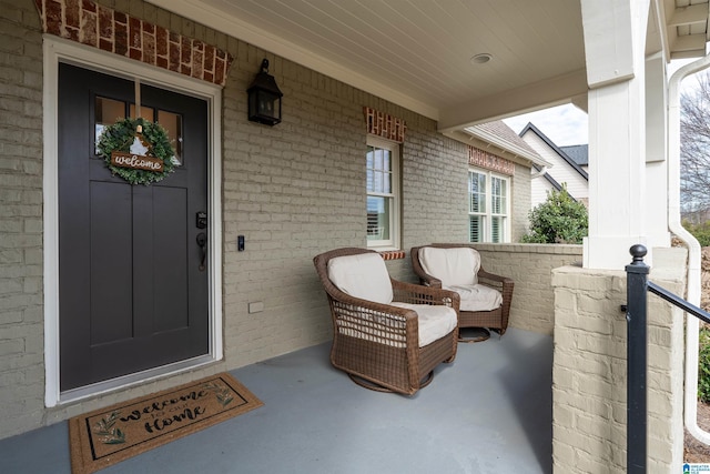 view of exterior entry with covered porch