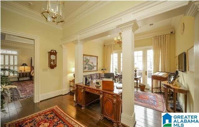 home office with ornamental molding, decorative columns, and dark hardwood / wood-style floors