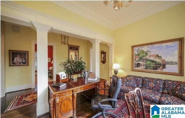 home office with hardwood / wood-style floors, decorative columns, and ornamental molding