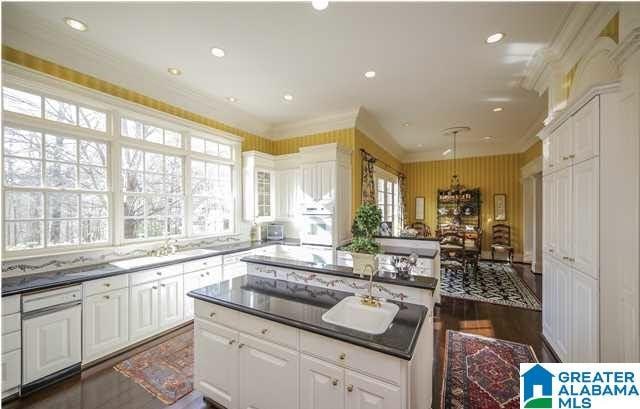 kitchen featuring ornamental molding, white cabinetry, dark hardwood / wood-style floors, and a center island