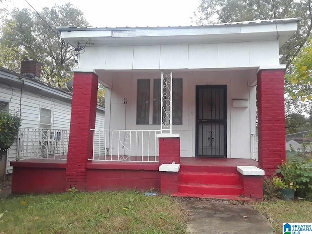 view of exterior entry with a porch