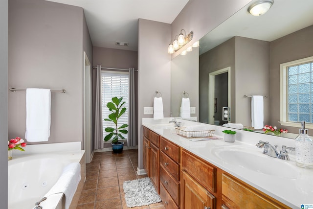 bathroom featuring tile patterned floors, vanity, and a bathtub