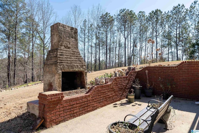 view of patio featuring an outdoor stone fireplace